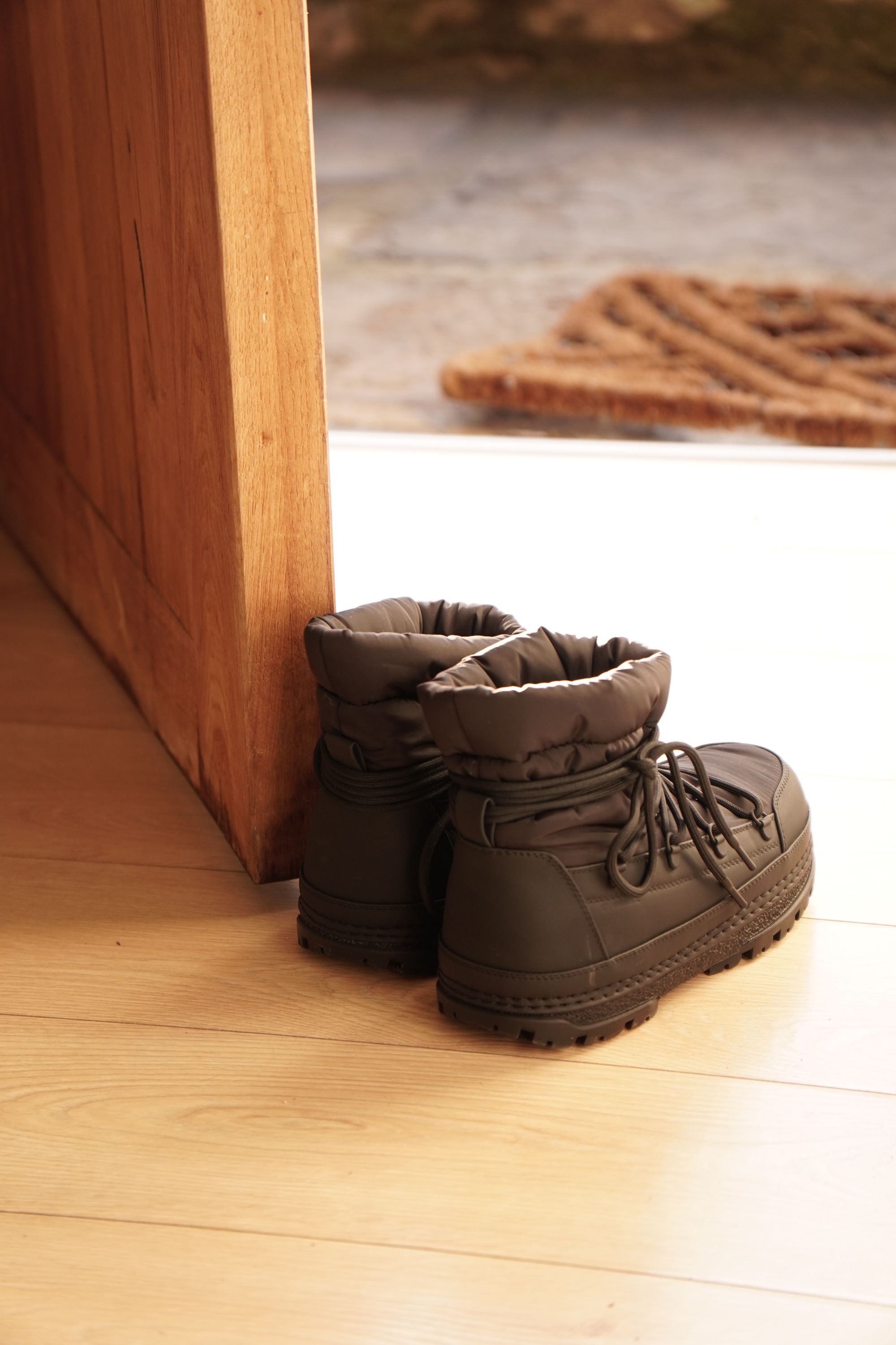 Illustrative boots by a doorway, no SOTHING product